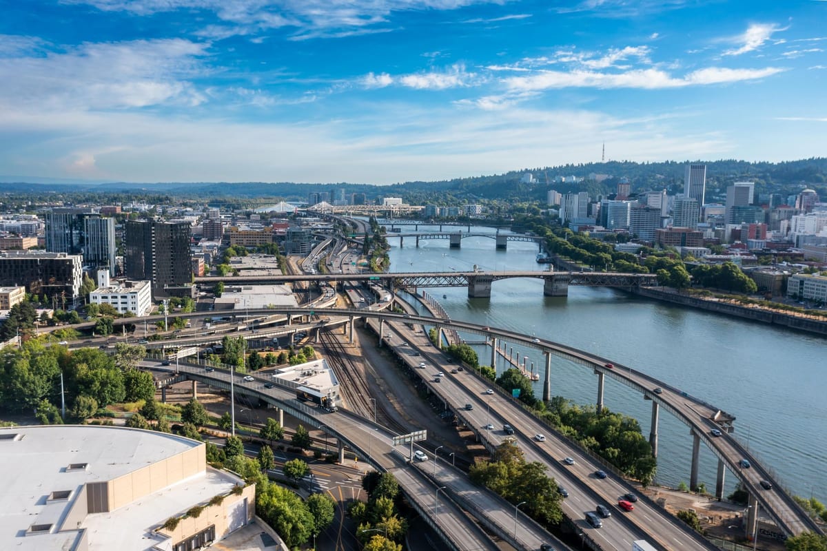 A river crossed by several bridges running through a downtown, seen from the air